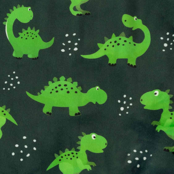Green dinosaur print dog pajamas fabric with white polka dots on dark green background.