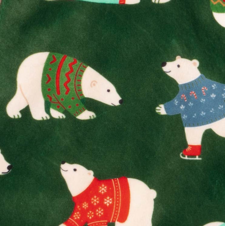 Close-up of polar bear sweater pattern on green dog pajamas, showing festive details.