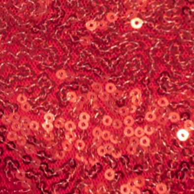 Close-up of red sequin fabric texture from a festive holiday dog dress.