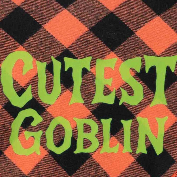 Detailed view of “Cutest Goblin” lettering on orange and black plaid dog bandanas.