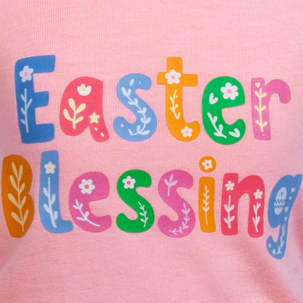 A colorful dog dress with "Easter Blessing" print and rainbow gingham skirt.