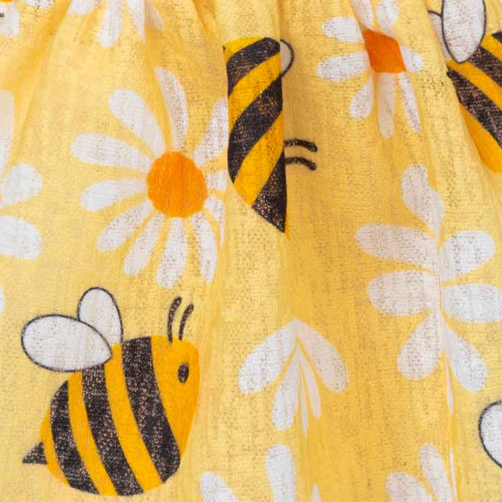 Yellow fabric details with bee and flower pattern
