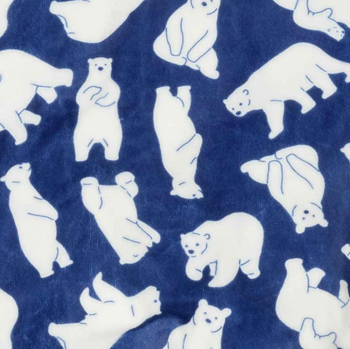 Close-up of a plush fabric featuring a repeating pattern of white polar bears on a blue background.