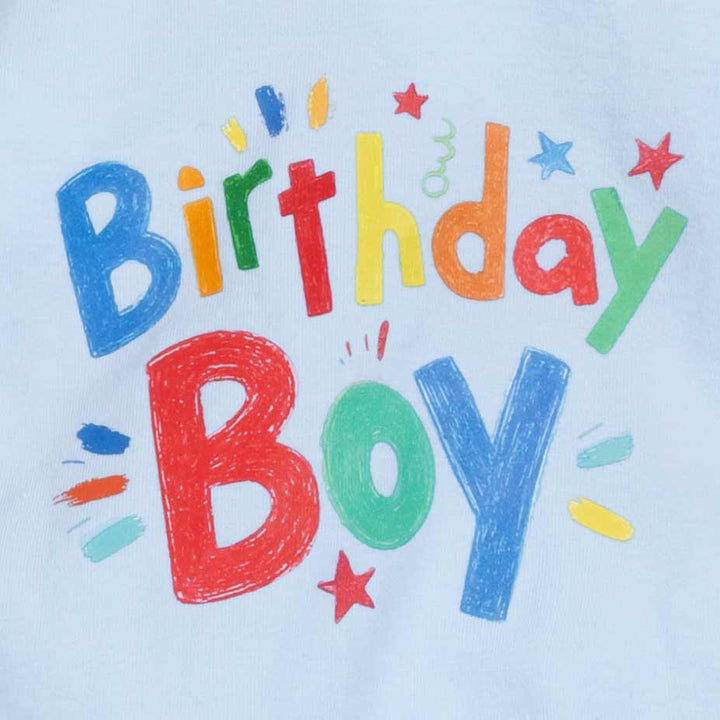 Birthday Boy graphic print detail on light blue dog pajamas with bright playful colors.