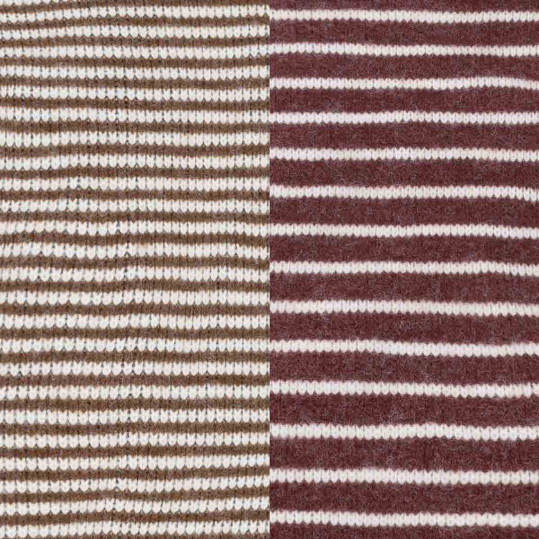 Close-up of a striped knit fabric with alternating sections of brown and burgundy horizontal stripes on a cream background
