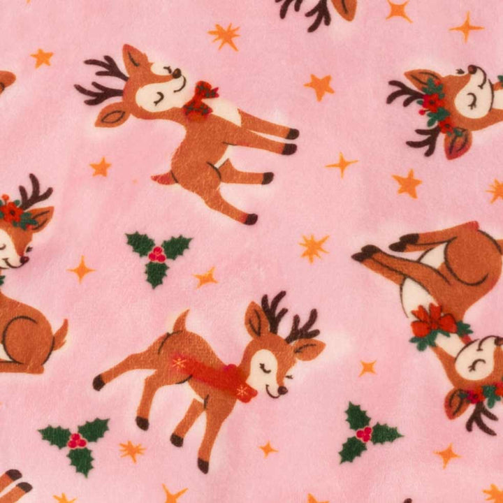 Pink dog Christmas pajamas with a cute reindeer, holly, and star pattern. Festive holiday dog apparel.
