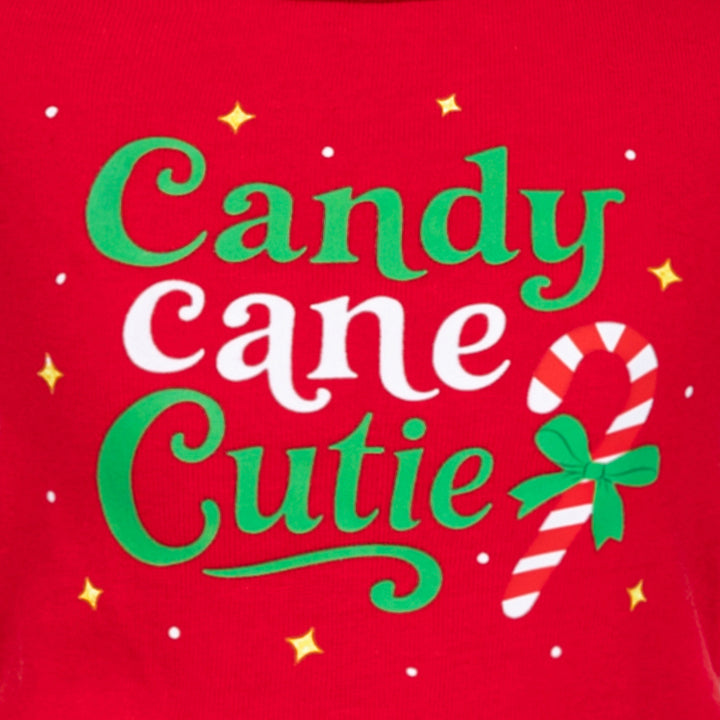 Close-up of 'Candy Cane Cutie' text printed on red Christmas Dog dress