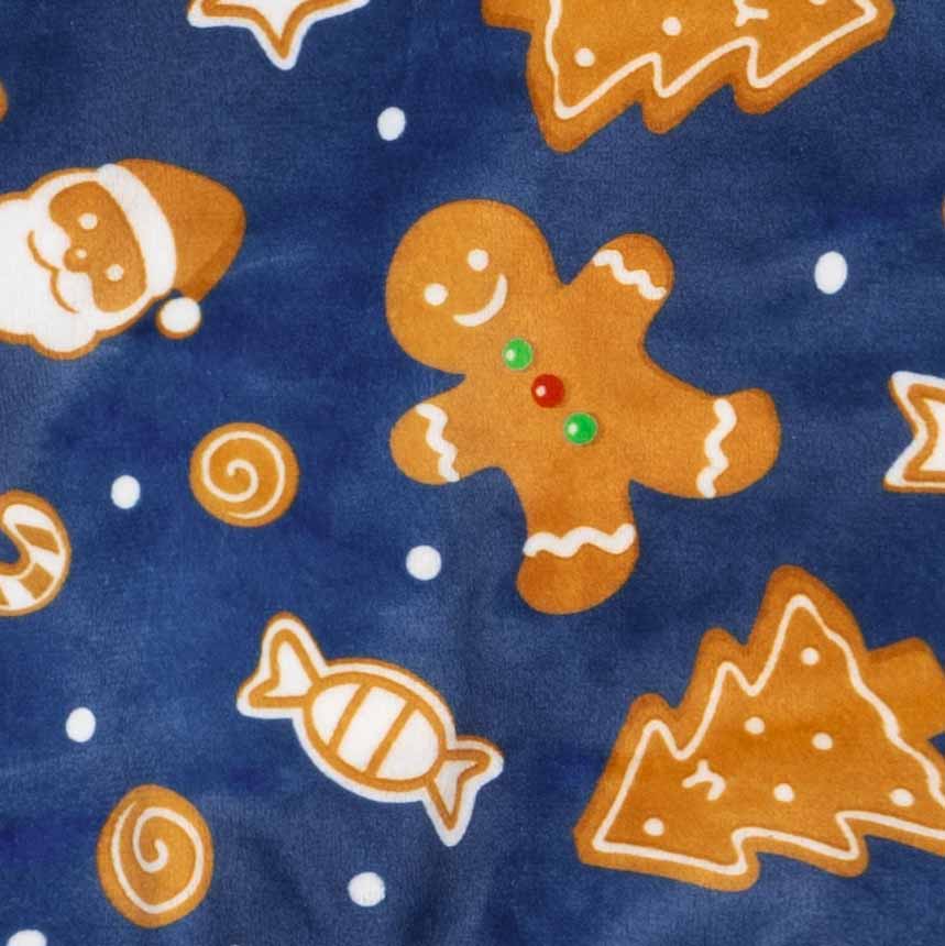 Gingerbread men, Christmas trees, and candies printed on blue velvet dog pajamas.