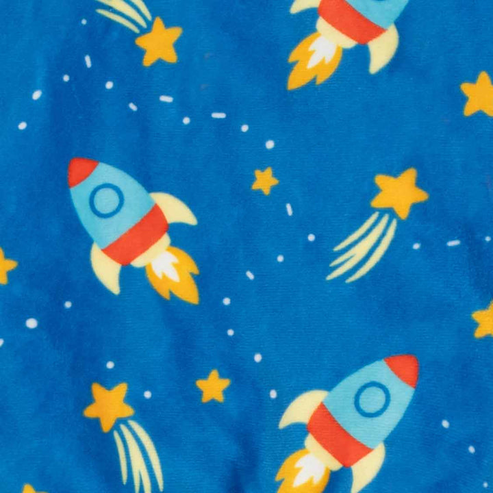 Close-up of blue fabric printed with a repeating pattern of colorful rockets and yellow stars