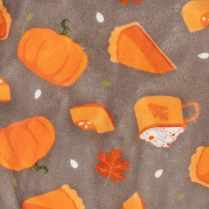 Brown fabric for dog pajamas with festive orange pumpkin, pie, maple leaf, and coffee cup patterns.