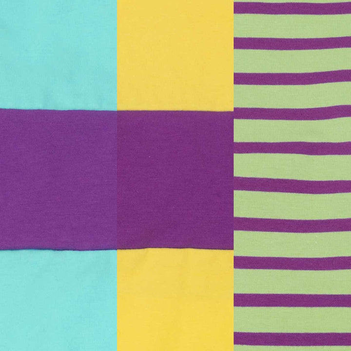 Colorful fabric with squares and stripes in purple, yellow, and green.
