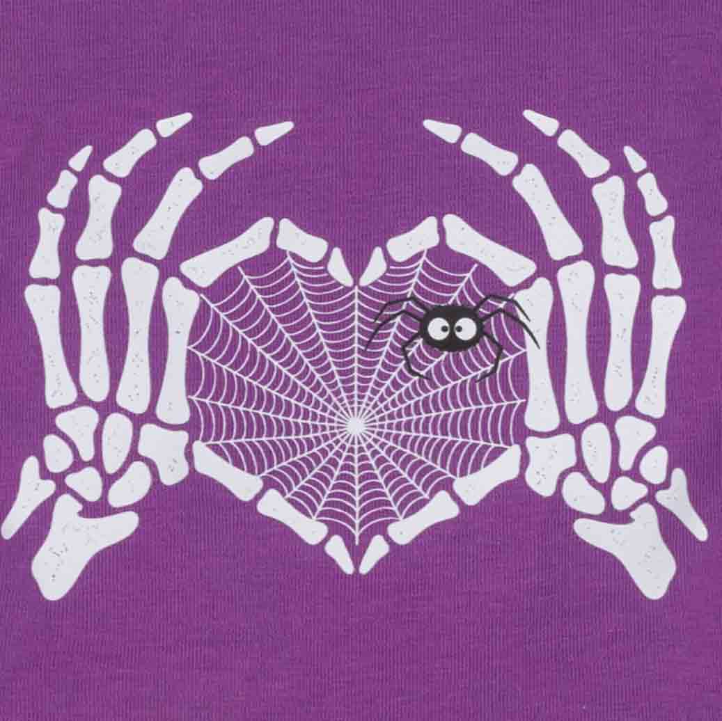 Close-up of a purple fabric of spooky dog dress featuring a white skeleton hands graphic holding a white spiderweb heart, with a small black spider on the web
