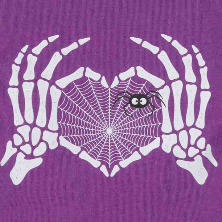 Close-up of a purple fabric of spooky dog dress featuring a white skeleton hands graphic holding a white spiderweb heart, with a small black spider on the web