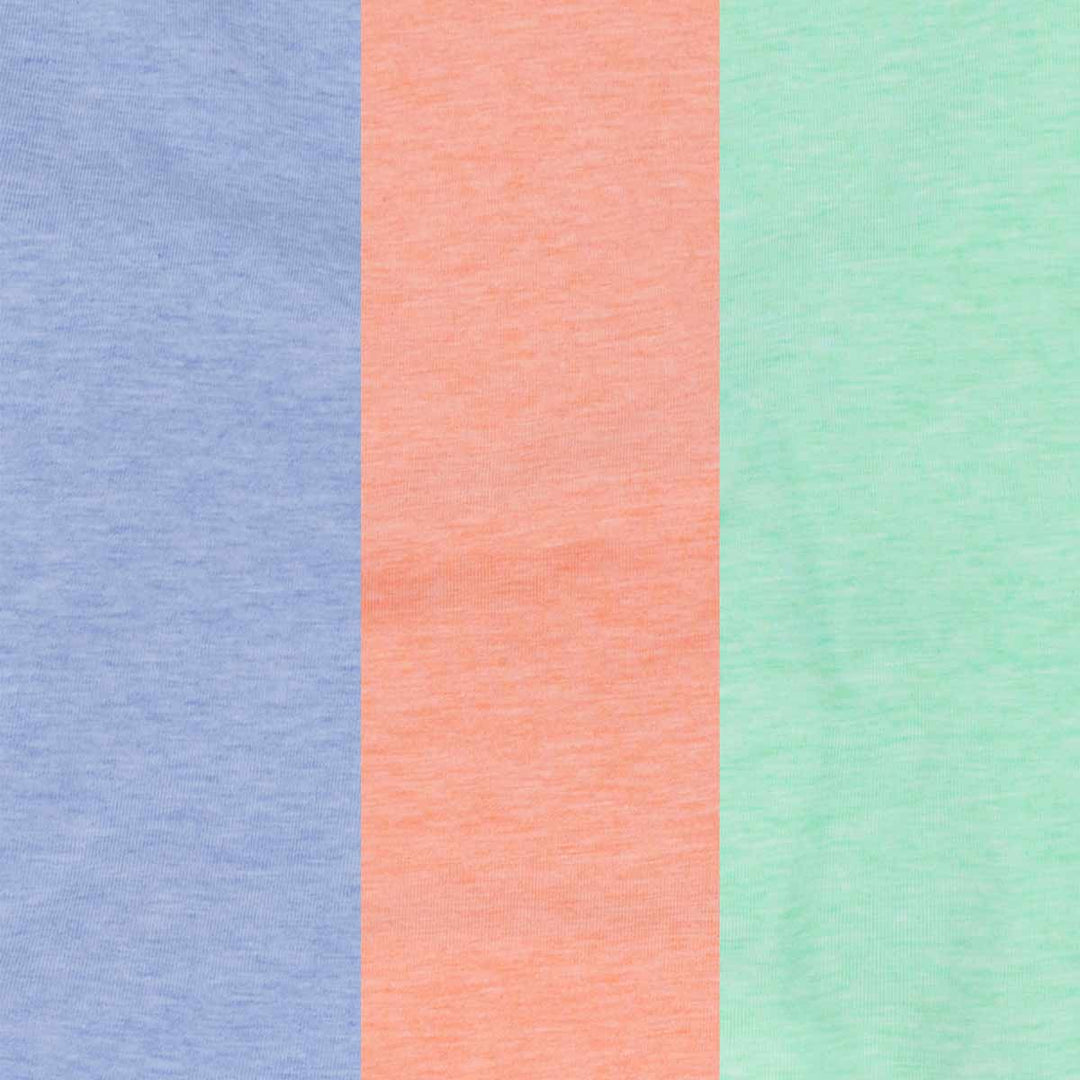 Close-up of the blue, peach, and green dog shirts displaying the soft cotton fabric texture.