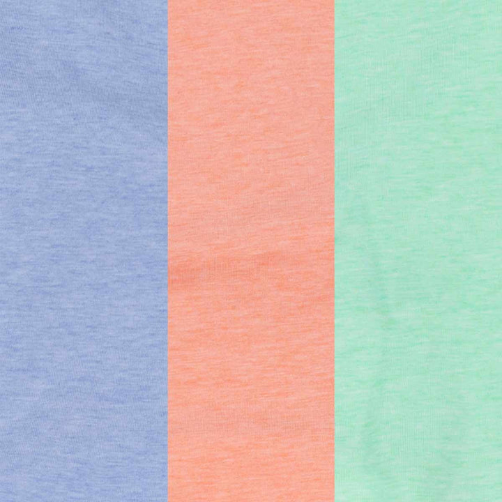 Close-up of the blue, peach, and green dog shirts displaying the soft cotton fabric texture.