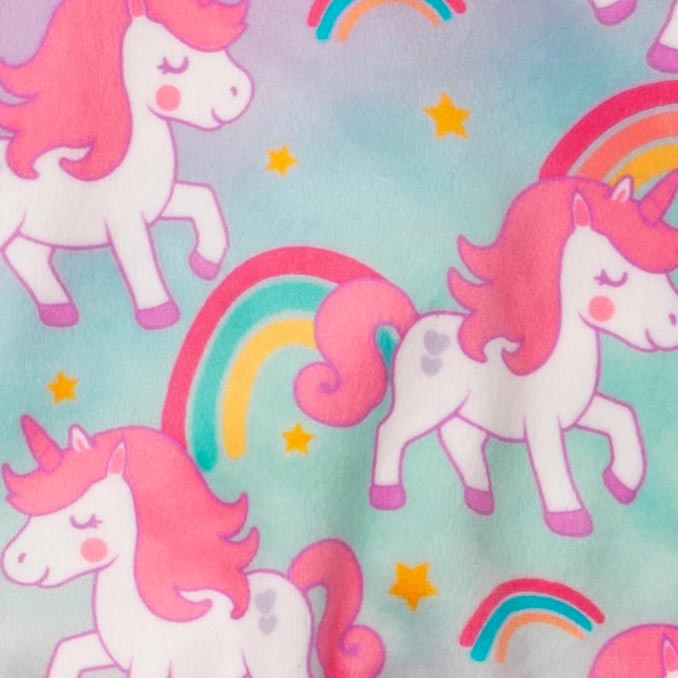 Pattern detail of unicorn dog pajamas featuring pink-maned unicorns, rainbows, and yellow stars on a pastel background.