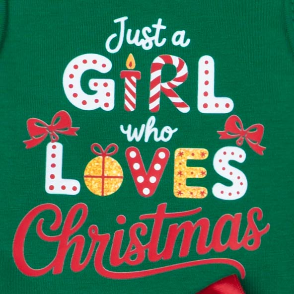 Lettering detail of dog dress with “Just a Girl Who Loves Christmas” festive design.
