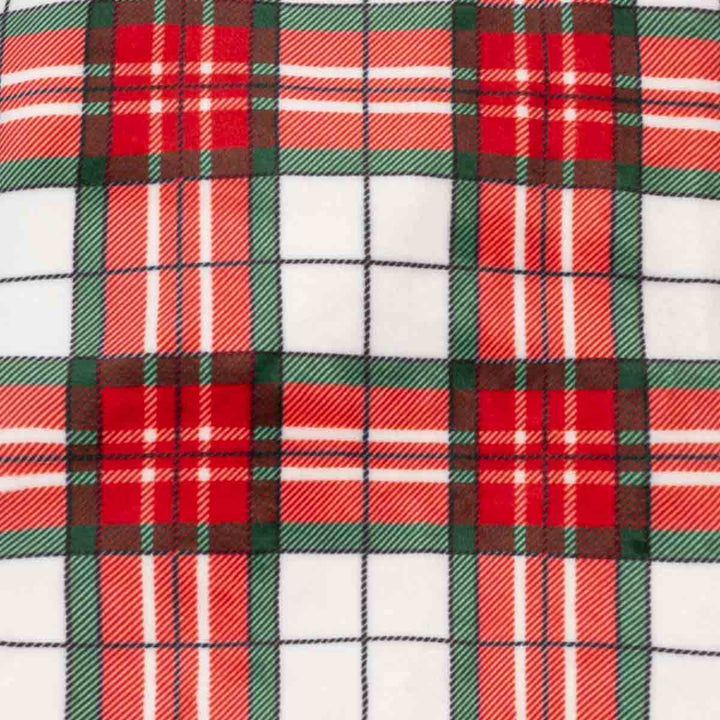 Close-up of a red, green, and white tartan plaid fabric pattern with a soft fleece texture