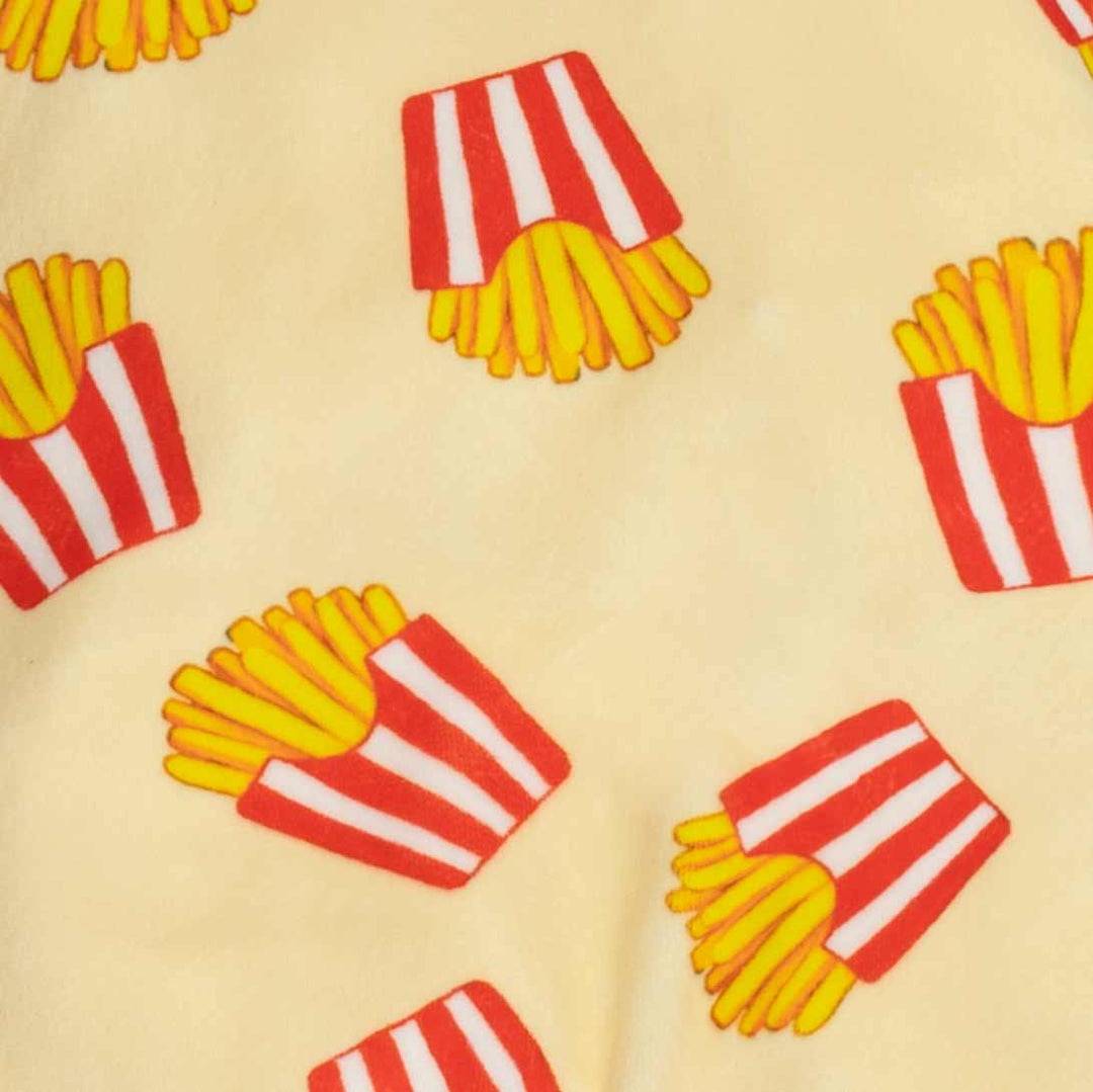 Close-up of a light beige fabric printed with a repeating pattern of red and white striped french fries