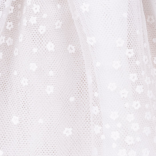 Close-up of a textured white fabric with small holes