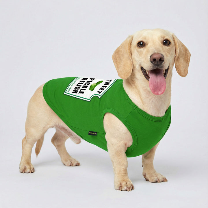 Happy dachshund standing and wearing a bright green shirt for dogs with a playful pickle relish graphic