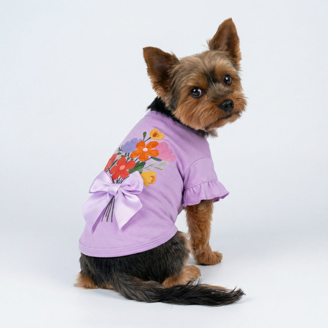 Back view of a Yorkie wearing a purple shirt for dogs with flower and bowknot