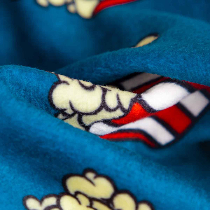 Close-up of blue popcorn dog pajamas fleece material with popcorn design, ideal for comfortable dog clothes.